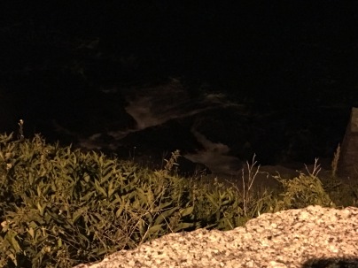 The ocean roared beneath us late at night along the rocky cliff walk.